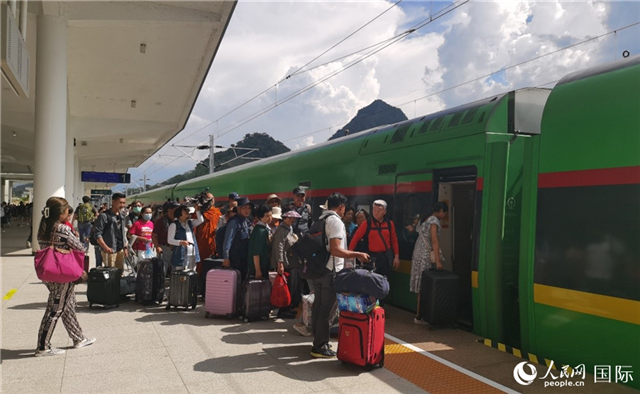 乘坐中老鐵路國(guó)際旅客列車的旅客在老撾瑯勃拉邦站排隊(duì)上車。人民網(wǎng)記者 杜明明攝