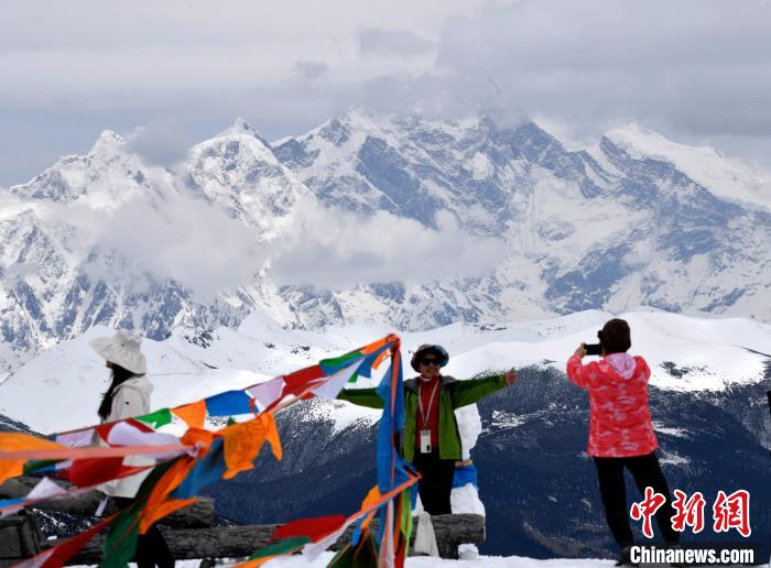 圖為5月14日，西藏林芝色季拉山觀景臺(tái)，游客與南迦巴瓦峰合影?！±盍?攝