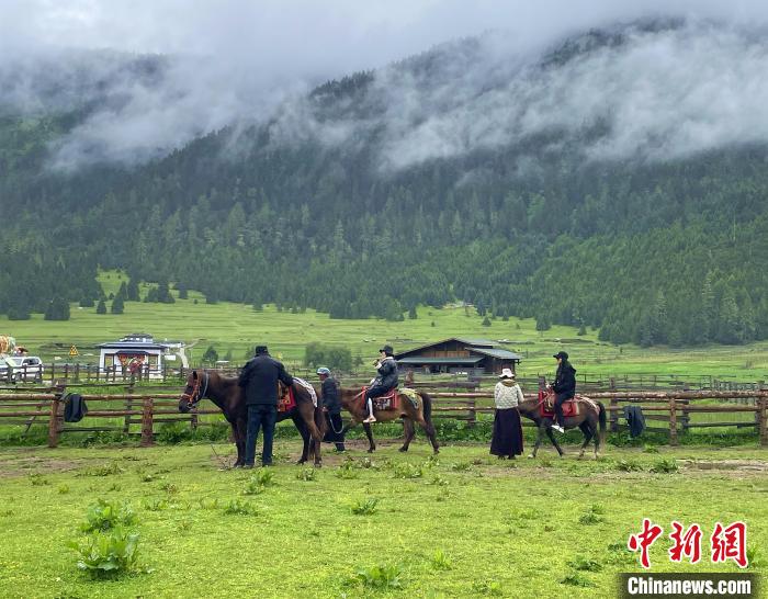 6月10日，游客在魯朗小鎮(zhèn)高山牧場景區(qū)體驗騎馬?！∪轿木?攝